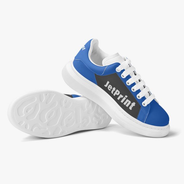 Side view of a pair of blue and black oversized sneakers with logo