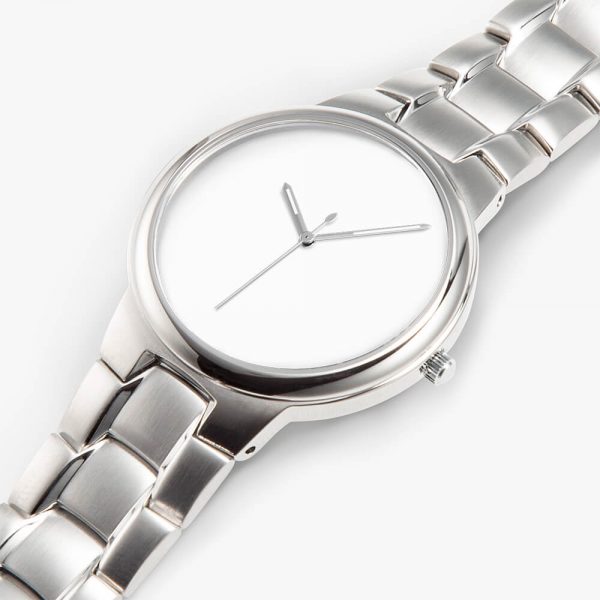 A silver stainless steel watch lies flat