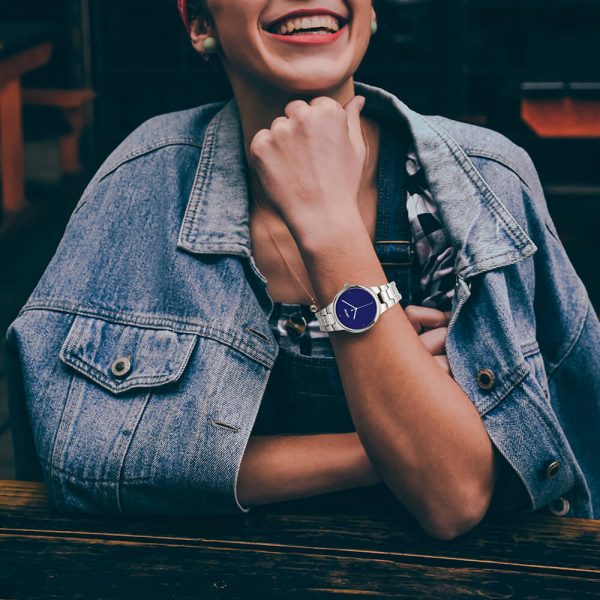 A female model smiles as she displays a stainless steel silver watch.