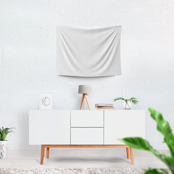 A pure white tapestry hangs on the wall, and there is a table beneath it.