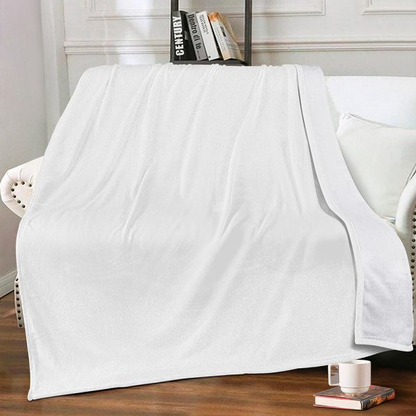 Pure white wool blanket is opened and placed on the sofa