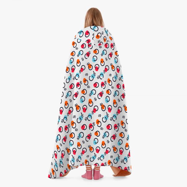 A female model wears a patterned hooded blanket