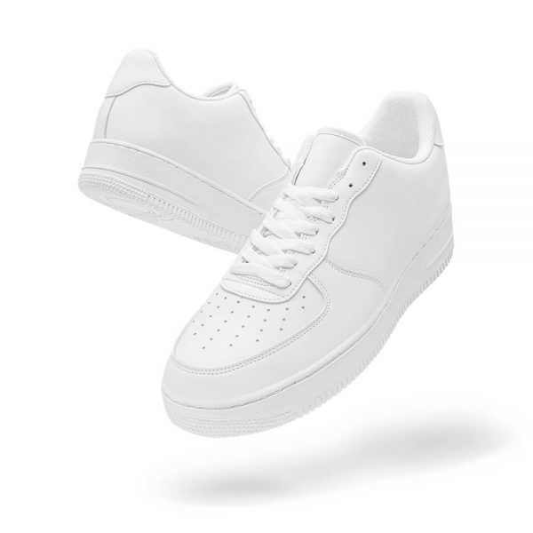 Side view of a pair of white low-top sneakers suspended in the air