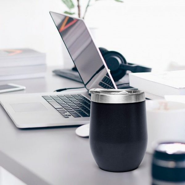 Black egg-shaped thermos is placed on the table