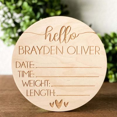 A wooden newborn sign