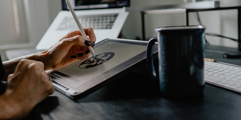 A woman is drawing on her tablet