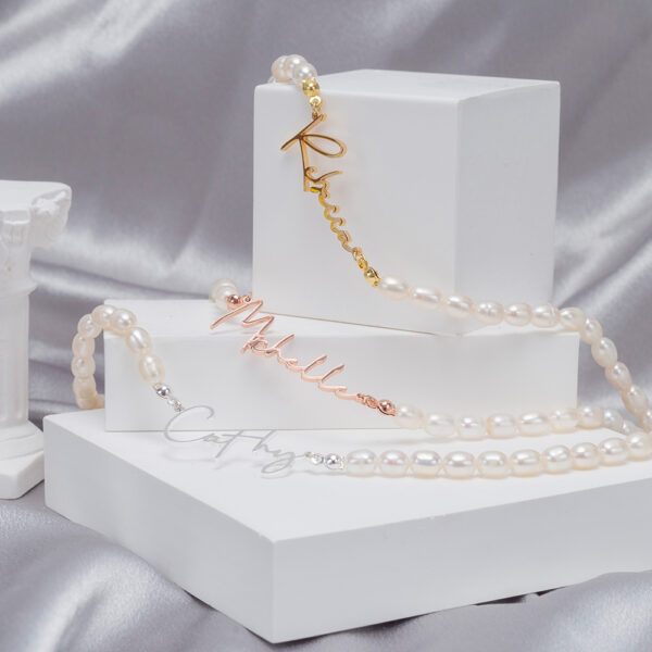 A pearl necklace is placed on a display stand