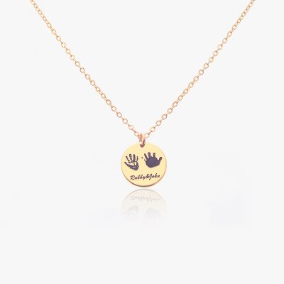 A golden handprint necklace