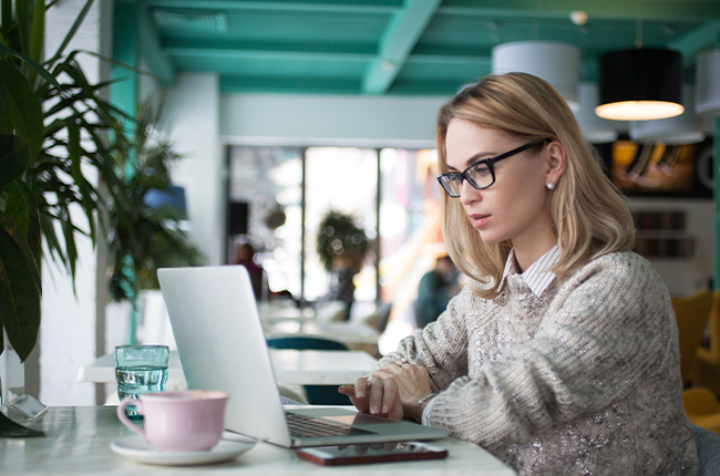 A woman is browsing affiliate program information in a restaurant