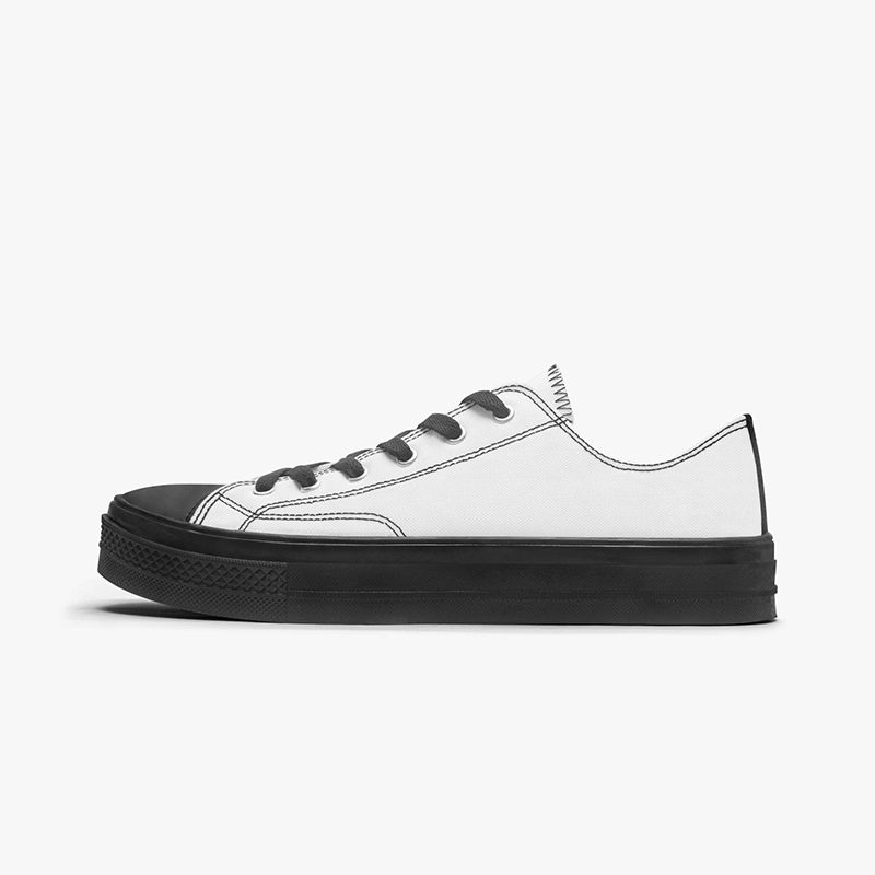 A pure white customizable black sole low top canvas shoes