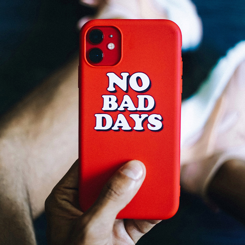 A person is holding a red mobile phone case