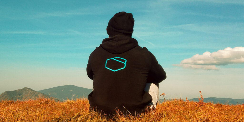 A schoolboy wears a black hoodie with simple shapes