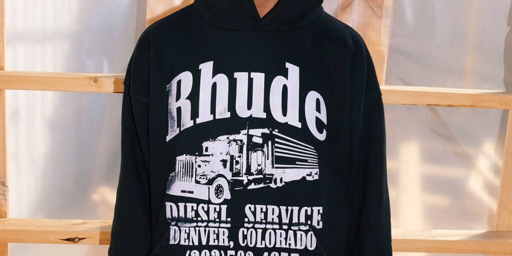 A man wearing a black hoodie with a retro truck