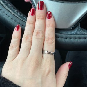 A woman wears a custom silver ring