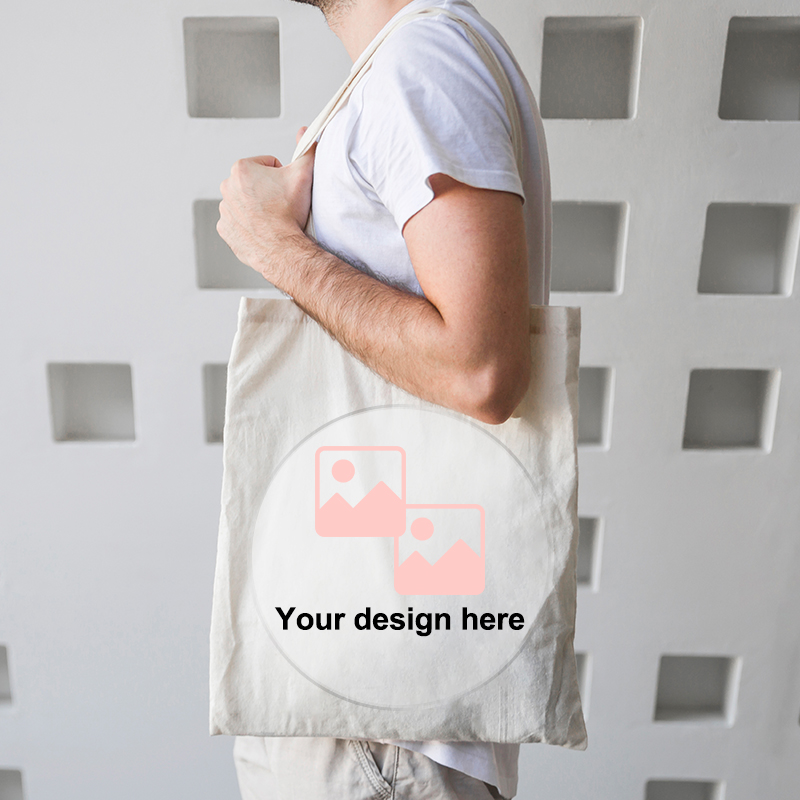 A male model is carrying a canvas tote bag