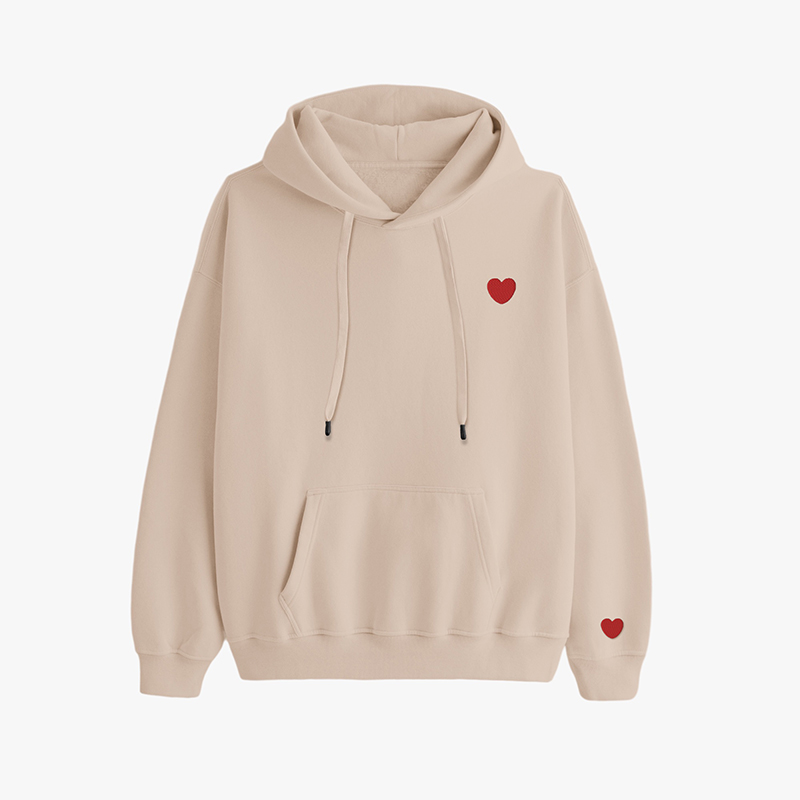 A brown hoodie with red heart embroidery