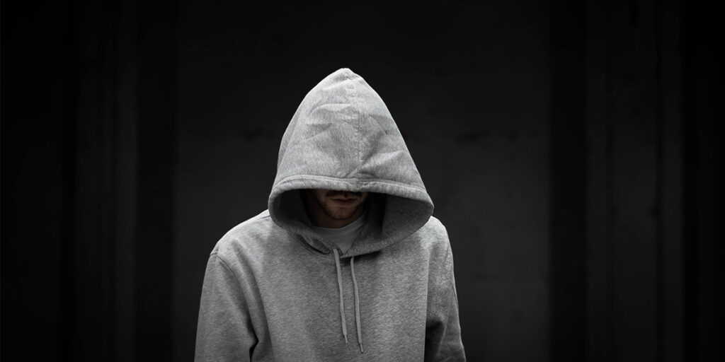 A man wearing a gray hoodie